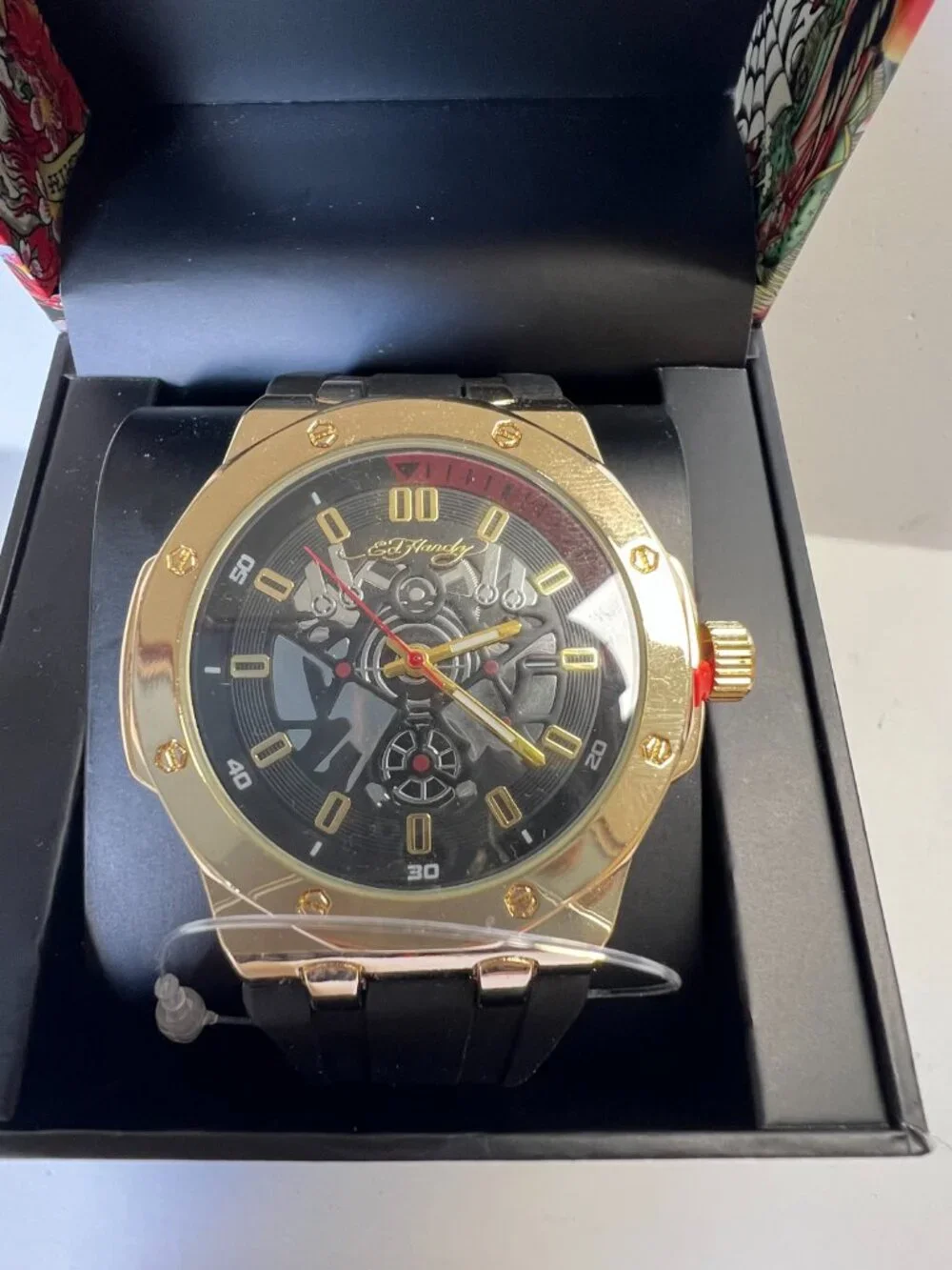 Ed Hardy men's sport wristwatch. Black rubber band. Gold case. Analog. Skeleton…